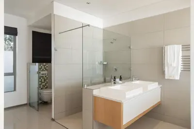 a white bathroom with a sink and a toilet at Benguela Cove - Lavender Dreams in Hermanus