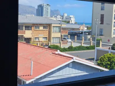 a view of a building with a red roof at Strand Beach Apartment in Cape Town