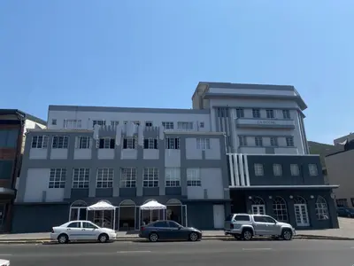 a building with three cars parked in front of it at The Silhouette - Paarl - Self Catering Apartment in Paarl