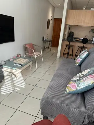 a living room with a couch and a table at The Silhouette - Paarl - Self Catering Apartment in Paarl