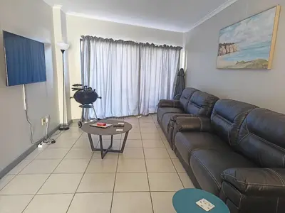 a living room with a couch and a table at Nautica3 in Cape Town