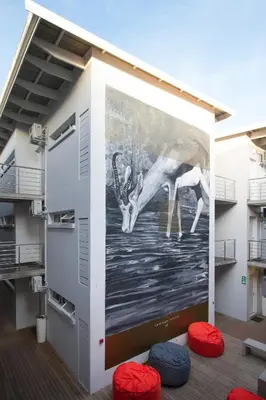 a mural on the side of a building at WINK Aparthotel Quiver Tree in Stellenbosch