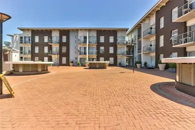 an empty courtyard of an apartment building at WINK Aparthotel Quiver Tree in Stellenbosch