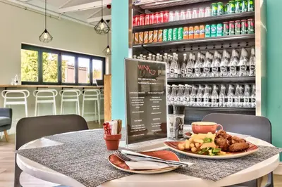 a table with a plate of food on it at WINK Aparthotel Quiver Tree in Stellenbosch
