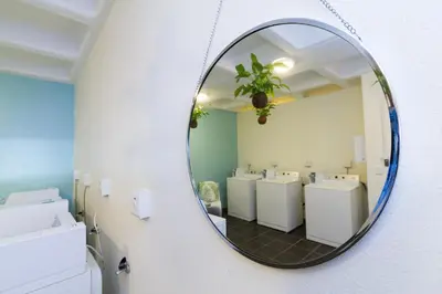 a mirror in a bathroom with a row of sinks at WINK Aparthotel Quiver Tree in Stellenbosch