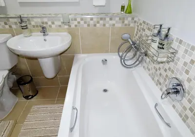 a bathroom with a tub and a sink and a toilet at Cape Town Luxury Stays Knightsbridge Luxury Apartment Century City in Cape Town