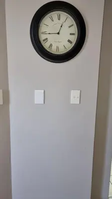a clock on a white wall above a door at Corner View in Paarl