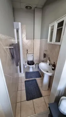 a bathroom with a toilet and a sink at Corner View in Paarl