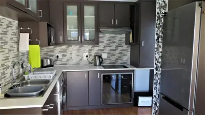 a kitchen with gray cabinets and a sink at Tucker's Self Catering Flatlet in Cape Town