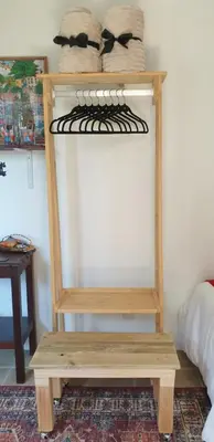 a wooden shelf in a room with a wooden table at Hibiscus B&B in Strand