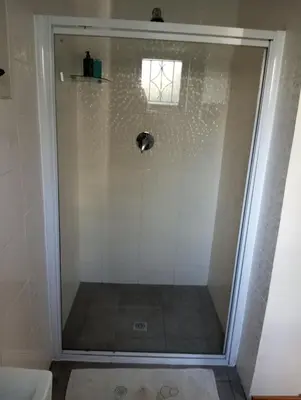 a shower with a glass door in a bathroom at Rusticana in Cape Town