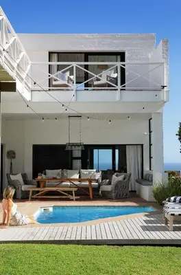 a living room with a pool and a house at Best of Both! Mountain and Sea View Home. in Hermanus