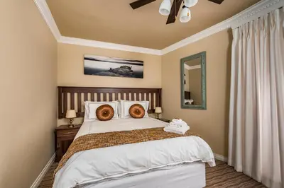 a bedroom with a bed with two donuts on it at Guesthouse De Tijger Lodge in Parow
