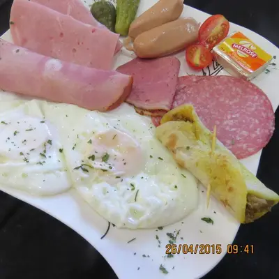 a plate of food with eggs meat and other foods at Guesthouse De Tijger Lodge in Parow