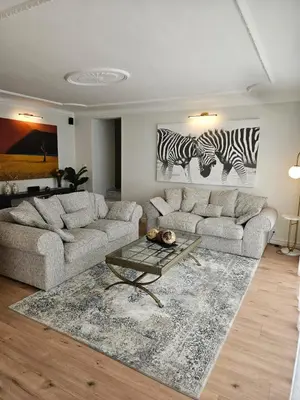 a living room with two couches and a rug at Casa La Vista in Somerset West