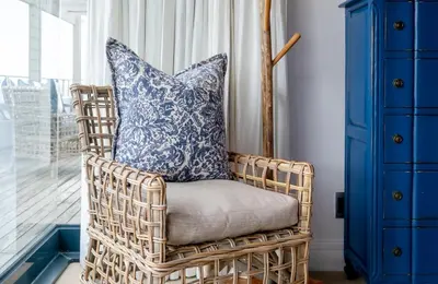 a wicker chair with a pillow in a room at Le Paradis Penthouse in Hermanus