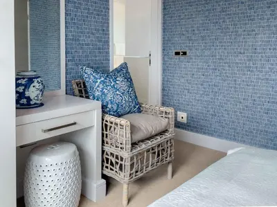a room with a chair and a table with a mirror at Le Paradis Penthouse in Hermanus