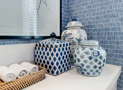 a shelf with blue and white vases and towels at Le Paradis Penthouse in Hermanus