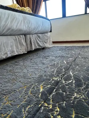a bedroom with a bed and a rug on the floor at Stay with me in Cape Town