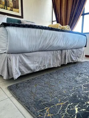 a couch with a rug next to a window at Stay with me in Cape Town