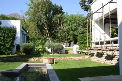 a yard with a pool and a building at The Cottage on 55 in Franschhoek
