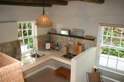 a kitchen with a sink and a counter top at The Cottage on 55 in Franschhoek