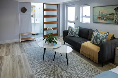 a living room with a couch and a table at The One on Pienaar in Cape Town