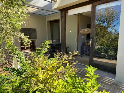 a porch of a house with plants in front of it at Luxury Vineyard Apartment in Cape Town