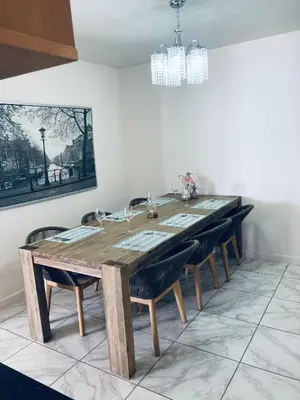 a dining room with a wooden table and chairs at Hibernian 10.02 in Cape Town
