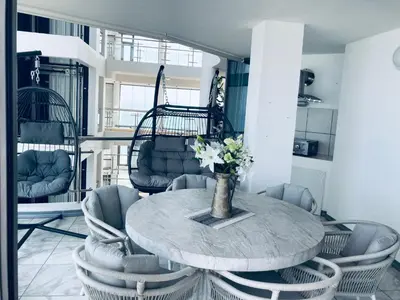 a dining room with a table and chairs at Hibernian 10.02 in Cape Town