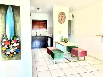 a kitchen and dining room with a table and chairs at Cozy&warm apartment in Century city in Cape Town