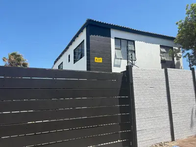 a black fence in front of a house at Serenity Hideaway in Cape Town