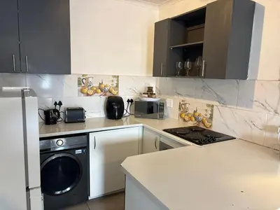 a kitchen with a refrigerator and a dishwasher at Serenity Hideaway in Cape Town