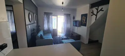 a living room with a couch and a chair at Serenity Hideaway in Cape Town