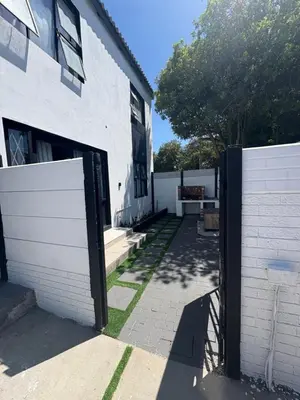 a white building with a gate in front of it at Serenity Hideaway in Cape Town