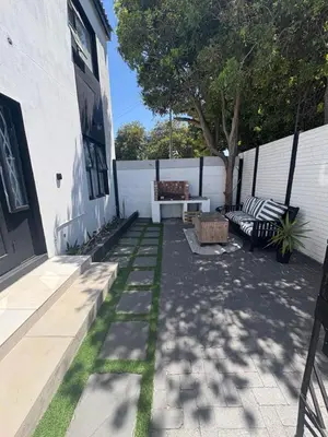a patio with two benches and a tree at Serenity Hideaway in Cape Town