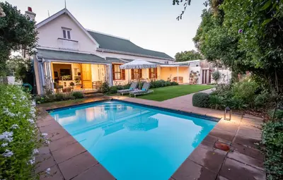 a swimming pool in the backyard of a house at Bonne Esperance Villa in Stellenbosch