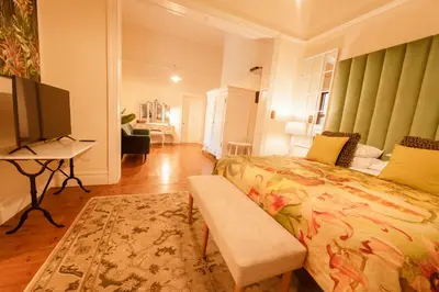 a bedroom with a bed and a flat screen tv at Bonne Esperance Villa in Stellenbosch