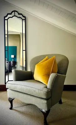 a couch with two pillows on it in a room at Calais Guest House in Franschhoek