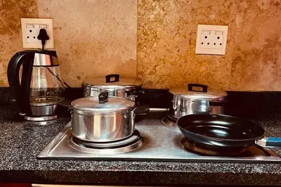 a stove with pots and pans on top of it at Studio Apartment Paarl Central in Paarl