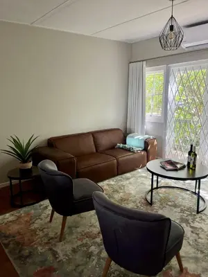 a living room with a couch and a table at Akker in Stellenbosch