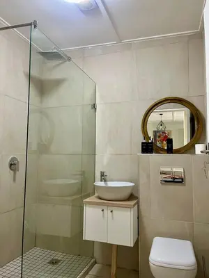 a bathroom with a sink and a glass shower at Akker in Stellenbosch