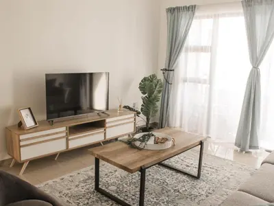 a living room with a television and a coffee table at Modern 2 bedroom apartment close to shops & beach in Gordonʼs Bay