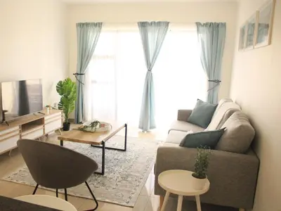 a living room with a couch and a tv at Modern 2 bedroom apartment close to shops & beach in Gordonʼs Bay