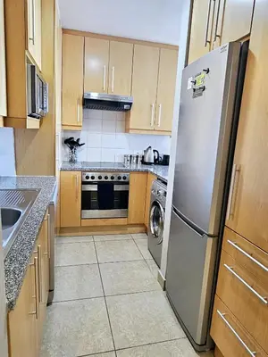 a kitchen with a stainless steel refrigerator and a dishwasher at Portico 1103 in Cape Town
