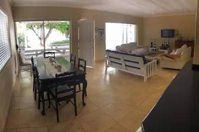 a living room with a table and a couch at House in Hermanus Voëlklip in Hermanus
