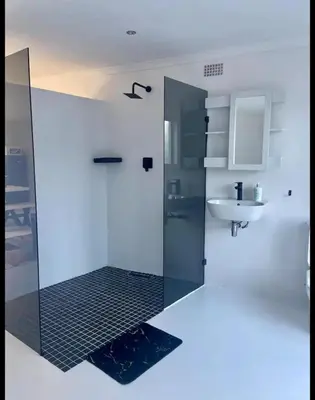 a bathroom with a shower and a sink at BREATHE On SOUTH in Cape Town