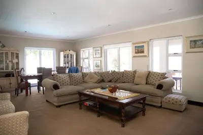 a living room with a couch and a table at House Simon in Somerset West