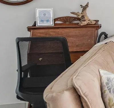 a bedroom with a bed and a dresser with a chair at WiFi & Solar at Studio on Morgenster in Cape Town