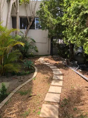 a garden with a walkway in front of a house at Dusk 2 Dawn Self Catering Guest House in Cape Town
